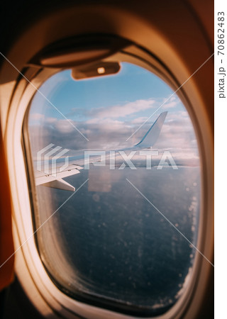 Airplane interior with window view of the Baltic sea and clouds. Airplane interior with window view of the Baltic sea and clouds. 70862483
