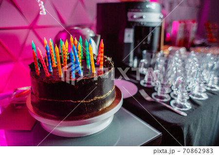 Birthday cake with candles, bright lights bokeh. 70862983