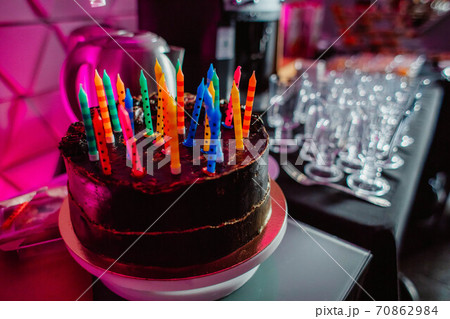 Birthday cake with candles, bright lights bokeh. 70862984
