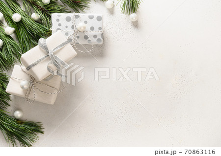 Christmas white gifts and evergreen branches. Christmas white gifts and evergreen branches. 70863116