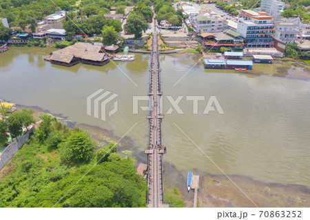 Aerial view of River Kwai Bridge with train rail way with Chao Phraya River, Tha Ma Kham, Mueang Kanchanaburi District, Thailand. Aerial view of River Kwai Bridge with train rail way with Chao Phraya River, Tha Ma Kham, Mueang Kanchanaburi District, Thailand. 70863252