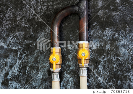 fragment of a household gas pipeline in the kitchen with a fork and valves fragment of a household gas pipeline in the kitchen with a fork and valves 70863718