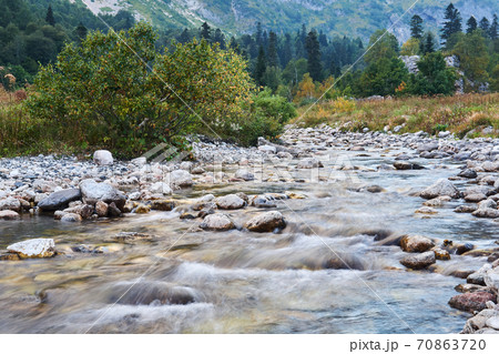 mountain river in autumn landscape, water blurred in motion 70863720