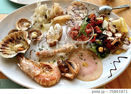 Delicious Italian seafood and fish antipasti platter as appetizer on wooden restaurant table. Gourmet food close up, snack, antipasti, seafood platter 70863871