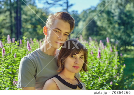 Young man and woman have date in park. Young man and woman have date in park. 70864266