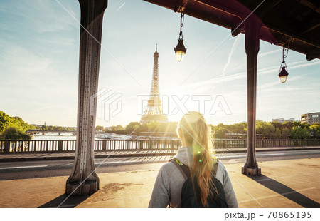 woman tourist walking  in front of the Eiffel Tower in Paris, France 70865195