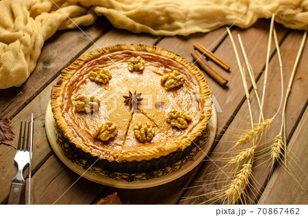 Fresh Homemade Pumpkin Pie on rustic wooden background made for Thanksgiving or halloween. Fresh Homemade Pumpkin Pie on rustic wooden background made for Thanksgiving or halloween. 70867462