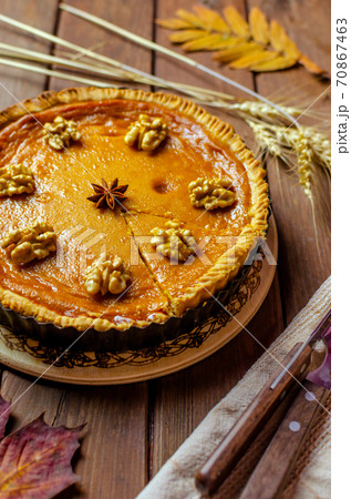 Fresh Homemade Pumpkin Pie on rustic wooden background made for Thanksgiving or halloween. Fresh Homemade Pumpkin Pie on rustic wooden background made for Thanksgiving or halloween. 70867463