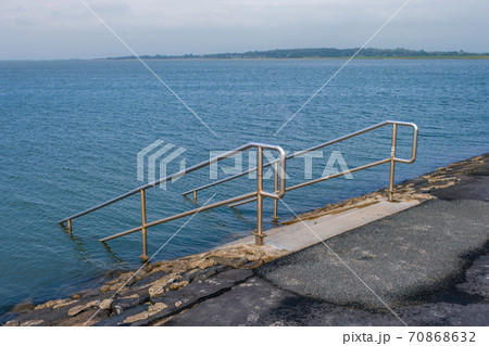A pier on the North Sea coast with a sign bathing is prohibited A pier on the North Sea coast with a sign bathing is prohibited 70868632