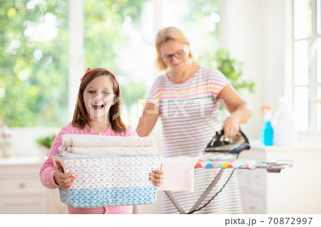 Woman ironing clothes. Home chores. Woman ironing clothes. Home chores. 70872997