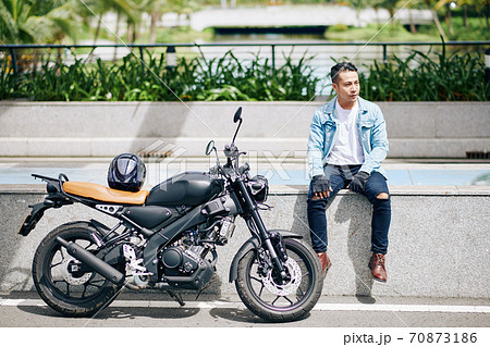Motorcyclist resting after ride Motorcyclist resting after ride 70873186