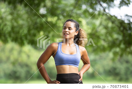 Healthy Lifestyle and Yoga Concept. Woman stretching her body during outdoor exercise session 70873401