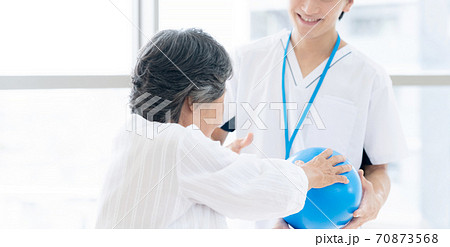 リハビリをするシニア女性と理学療法士 リハビリをするシニア女性と理学療法士 70873568