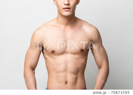 Healthy muscular upper body of a shirtless man isolated gray studio background 70873595