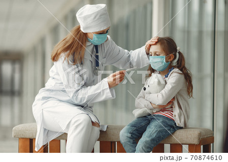 Doctor and a child in protective masks are in hospital 70874610