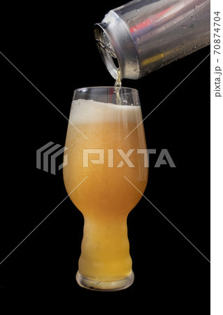 Serving beer from a can into an IPA beer glass Serving beer from a can into an IPA beer glass 70874704