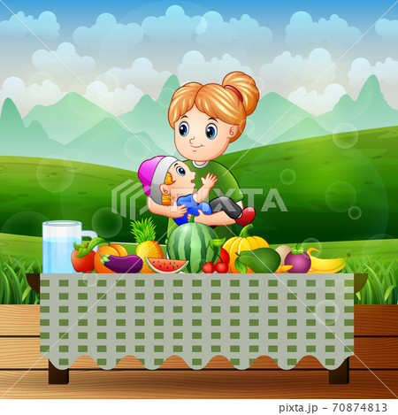 Mother and son with different fruits on the table 70874813