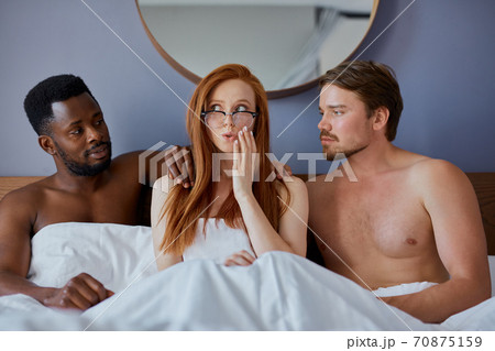 threesome concept. three people going to have group sex together threesome concept. three people going to have group sex together 70875159
