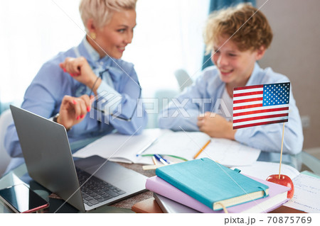 english tutor is engaged with the child, teaches languages at home english tutor is engaged with the child, teaches languages at home 70875769