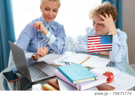 english tutor is engaged with the child, teaches languages at home english tutor is engaged with the child, teaches languages at home 70875770