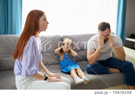 child girl is suffering from quarrels between parents in the family at home child girl is suffering from quarrels between parents in the family at home 70876308