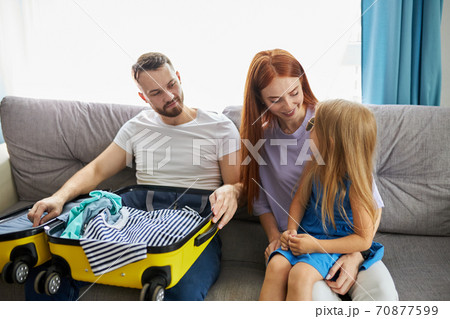 caucasian family with kid girl discuss what to take with them for holiday, vacation caucasian family with kid girl discuss what to take with them for holiday, vacation 70877599