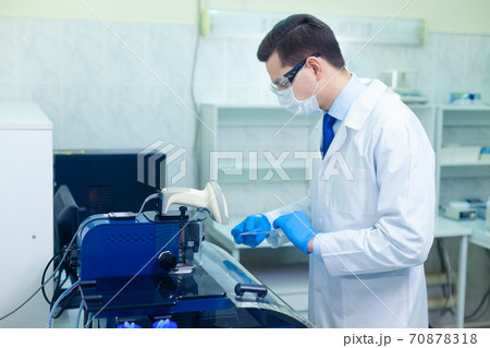 DNA laboratory. The expert puts the human DNA into the database using advanced laboratory technologies DNA laboratory. The expert puts the human DNA into the database using advanced laboratory technologies 70878318