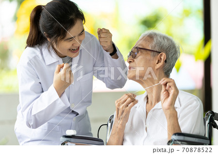 Asian senior woman listen,study how to use dental floss with professional female dentist,service or educate about oral health care,gums treat,teach teeth cleaning hygiene while visiting a nursing home Asian senior woman listen,study how to use dental floss with professional female dentist,service or educate about oral health care,gums treat,teach teeth cleaning hygiene while visiting a nursing home 70878522