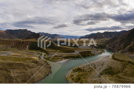 The confluence of Chuya and Katun rivers in Autumn. Green Hills and Mountains. Aerial View. The The confluence of Chuya and Katun rivers in Autumn. Green Hills and Mountains. Aerial View. The 70879966