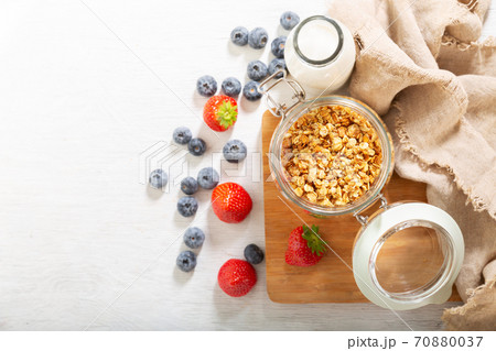 breakfast with granola, fresh berries and bottle of milk breakfast with granola, fresh berries and bottle of milk 70880037