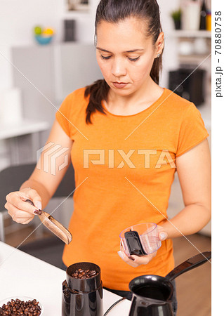 Using grinder to prepare the coffee 70880758