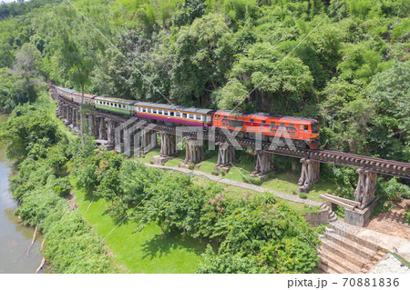 Aerial view of Thai local old classic train on railway on River Kwai Bridge in Kanchanaburi town, Thailand in public transportation concept. 70881836