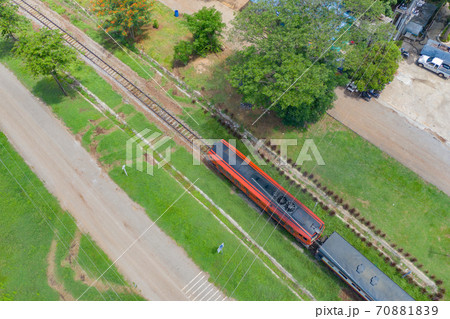 Aerial view of Thai local old classic train on railway on River Kwai Bridge in Kanchanaburi town, Thailand in public transportation concept. 70881839