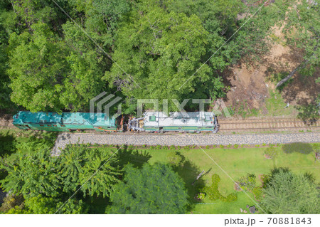 Aerial view of Thai local old classic train on railway on River Kwai Bridge in Kanchanaburi town, Thailand in public transportation concept. 70881843