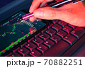 Stock market chart screen on keyboard computer and hand hold pen, online investment concept 70882251