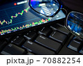 Stock market chart screen on keyboard computer and eyeglasses, online investment concept 70882254