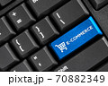 E-commerce word blue button on black keyboard computer, online store business concept 70882349