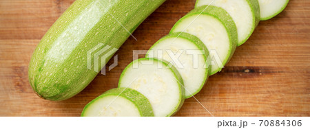 Slices of courgettes on wooden board 70884306