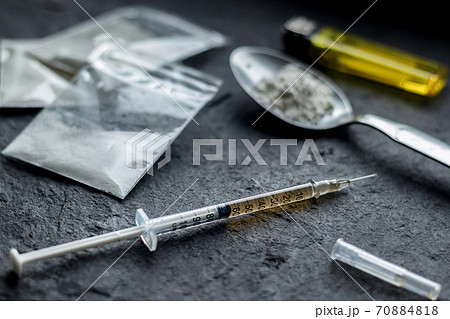 drug syringe and cooked heroin on spoon. drug addict problem and therapy concept drug syringe and cooked heroin on spoon. drug addict problem and therapy concept 70884818
