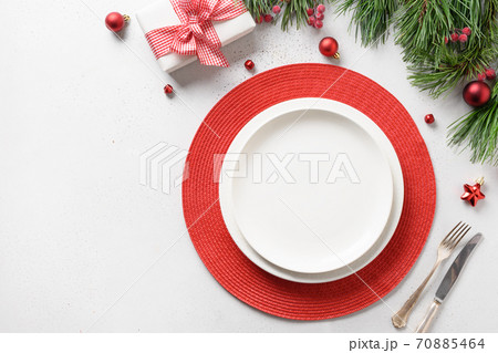 Christmas table setting with holiday decorations Christmas table setting with holiday decorations 70885464