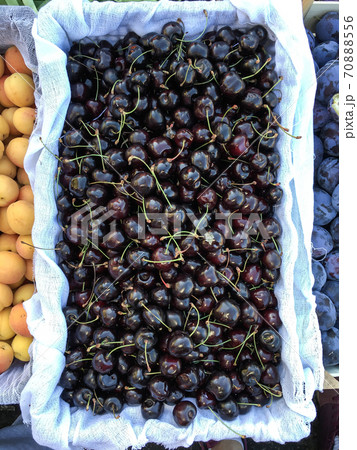 Group of ripe and fresh cherry at farmers market. Food shop with vegetables. Mobile photo Group of ripe and fresh cherry at farmers market. Food shop with vegetables. Mobile photo 70888556