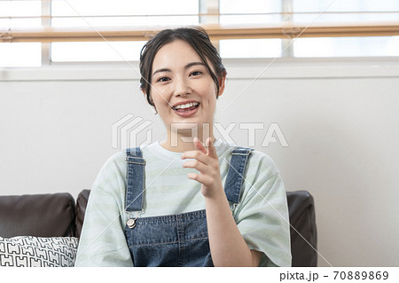 カメラ目線で話す若い女性 70889869