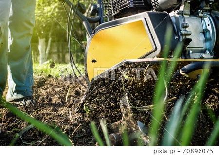 Grass and plowed soil nuggets during motor cultivator season work Grass and plowed soil nuggets during motor cultivator season work 70896075