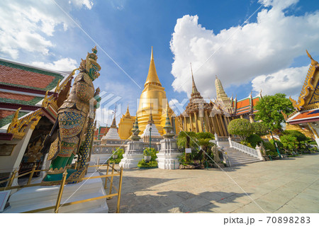 Giant guardian statue of Golden pagoda at Temple of the Emerald Buddha in Bangkok, Thailand. Wat Phra Kaew and Grand palace in old town, urban city. Buddhist temple, Thai architecture. 70898283