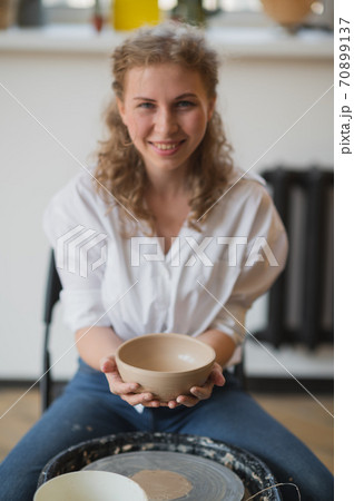 Master class on modeling of clay on a potter wheel In the pottery workshop Master class on modeling of clay on a potter wheel In the pottery workshop 70899137
