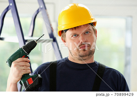 Idiot worker using electric drill portrait 70899429