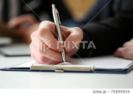 Male hand holding silver pen 70899839