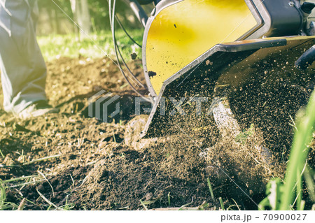 Close up view on fuzz soil nuggets during motor cultivator plow job 70900027