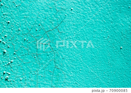 Surface of the old metal wall is covered with a lot of cracks, in which a rusty metal base is visible. Destruction of the old blue cracked paint. Grunge background texture. Surface of the old metal wall is covered with a lot of cracks, in which a rusty metal base is visible. Destruction of the old blue cracked paint. Grunge background texture. 70900085