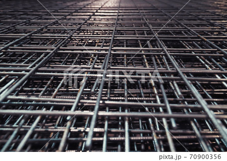 Steel bar for building materials. Wire reinforcing mesh. Industrial grunge background Steel bar for building materials. Wire reinforcing mesh. Industrial grunge background 70900356